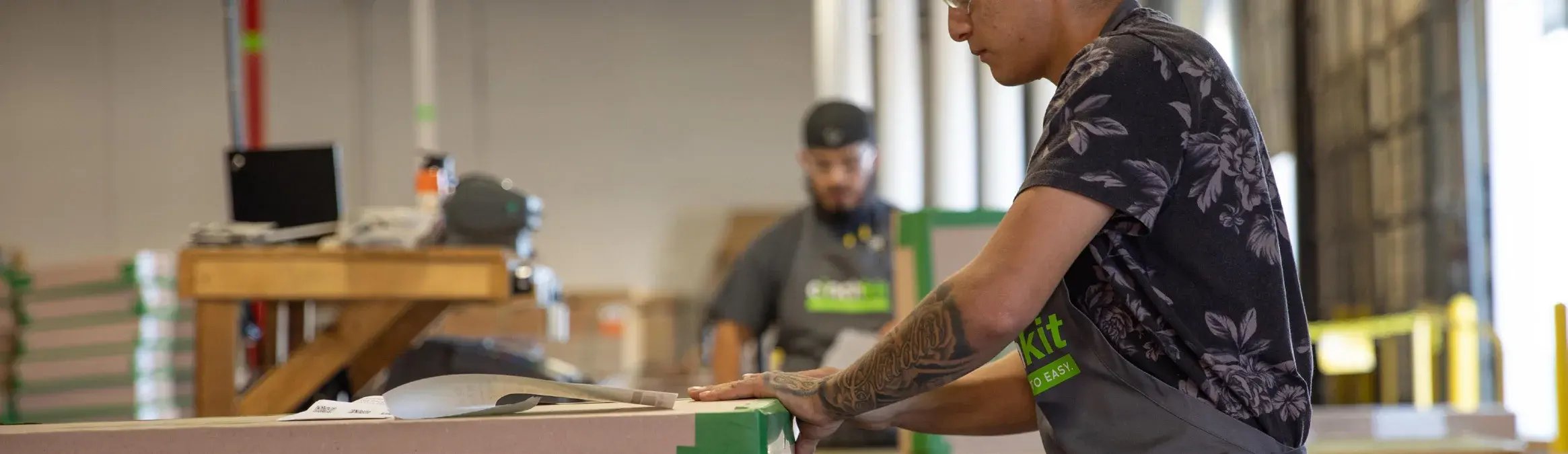 Qwikkit team members building cabinet refacing kits on the production floor