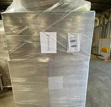 Wrapped pallet of Qwikkit kits staged for freight delivery