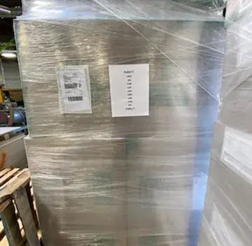 Shrink-wrapped pallet of Qwikkit cabinet refacing kits in the warehouse