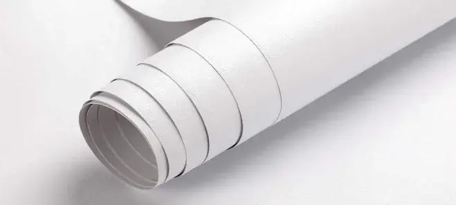 A roll of Qwikkit peel and stick cabinet film partly unrolled